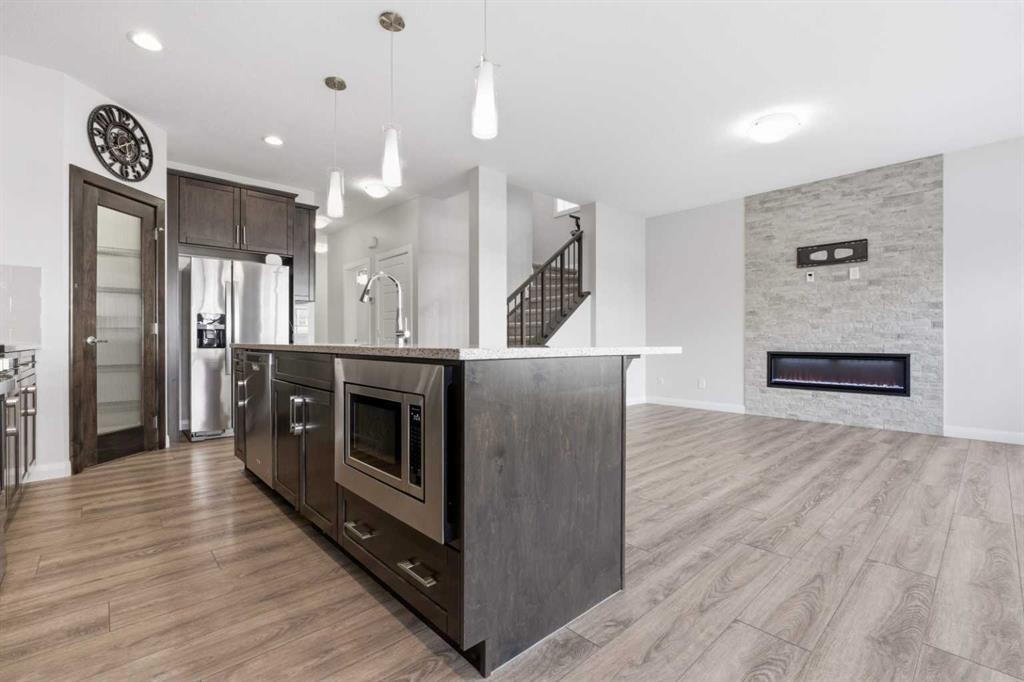 32 Red Embers Square Ne, Calgary, AB - Indoor Photo Showing Kitchen With Fireplace With Stainless Steel Kitchen With Upgraded Kitchen