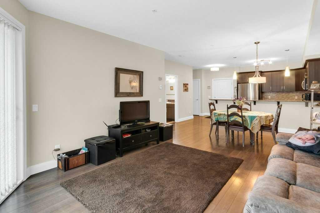 2104-15 Sunset Square, Cochrane, AB - Indoor Photo Showing Living Room