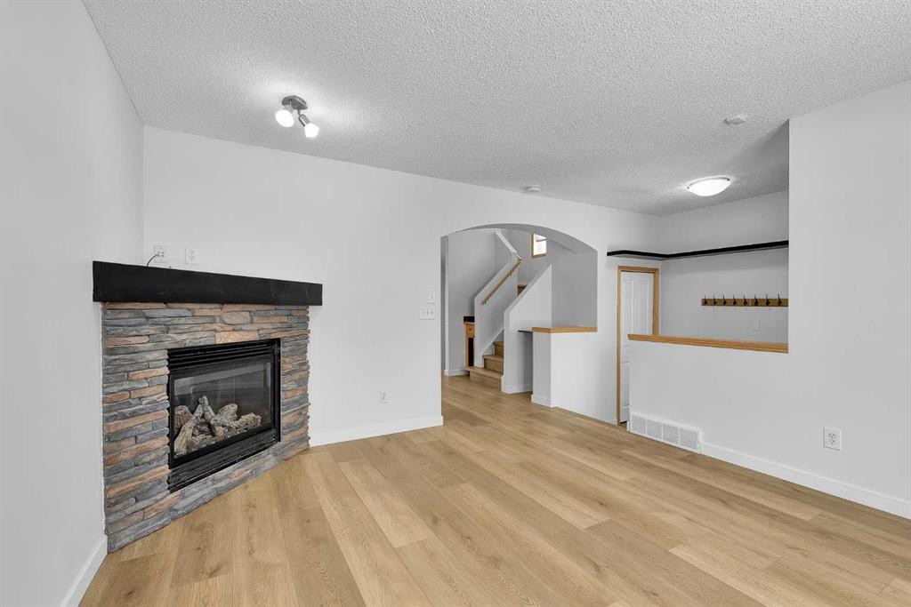 89 Covebrook Place Ne, Calgary, AB - Indoor Photo Showing Living Room With Fireplace