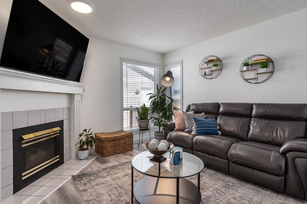 303 Coventry Close Ne, Calgary, AB - Indoor Photo Showing Living Room With Fireplace