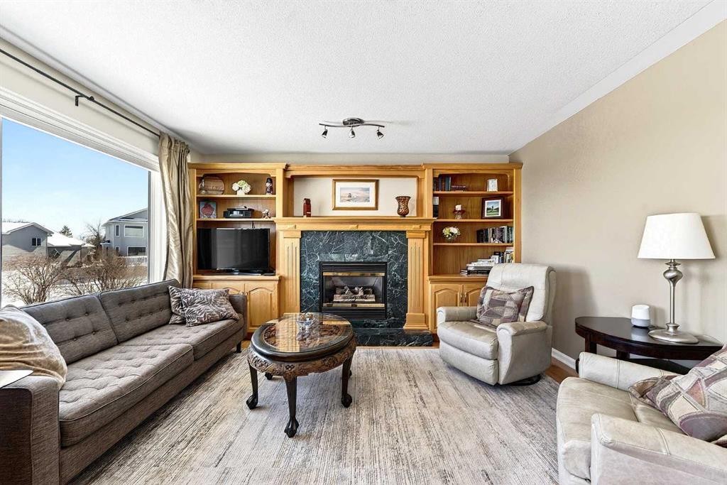 219 Hidden Ranch Circle Nw, Calgary, AB - Indoor Photo Showing Living Room With Fireplace