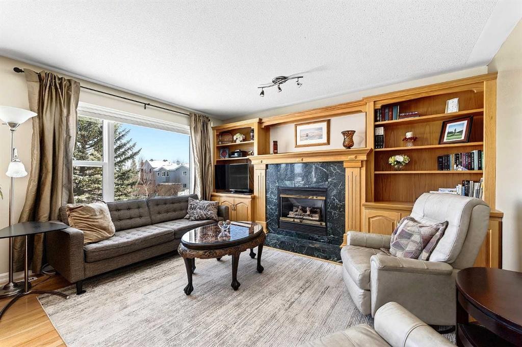 219 Hidden Ranch Circle Nw, Calgary, AB - Indoor Photo Showing Living Room With Fireplace