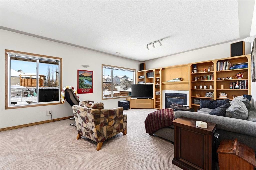 219 Hidden Ranch Circle Nw, Calgary, AB - Indoor Photo Showing Living Room With Fireplace