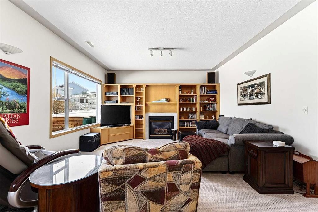 219 Hidden Ranch Circle Nw, Calgary, AB - Indoor Photo Showing Living Room With Fireplace