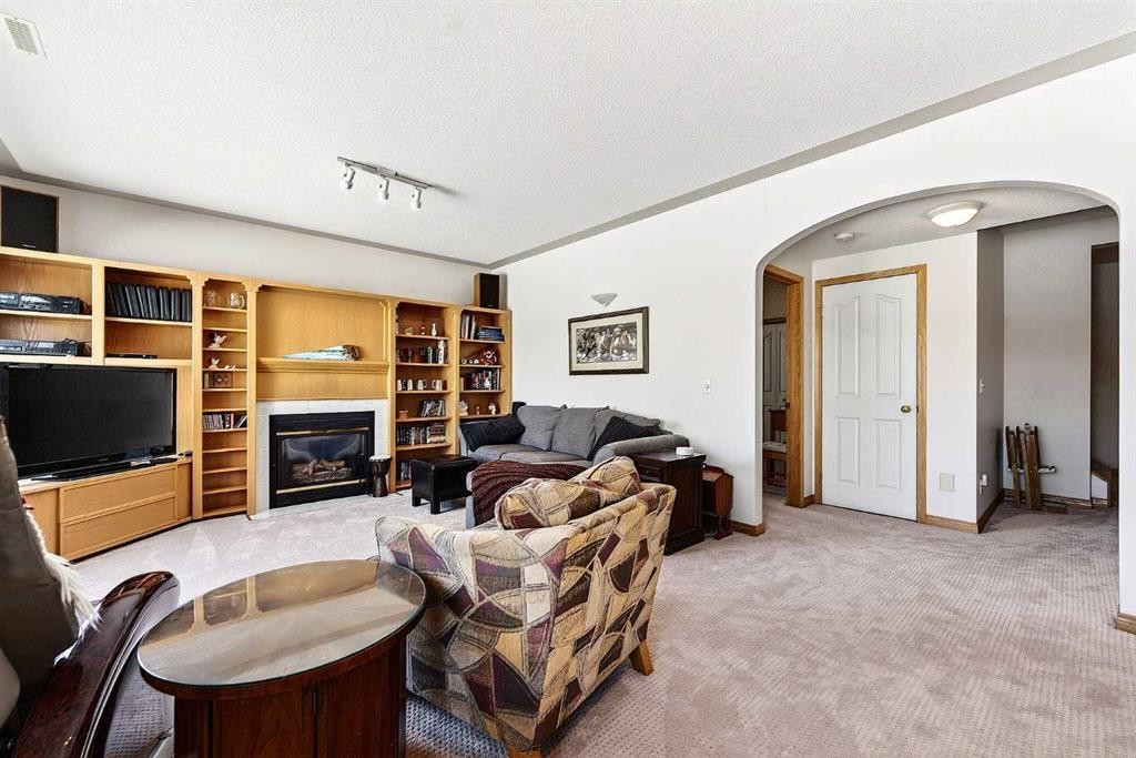 219 Hidden Ranch Circle Nw, Calgary, AB - Indoor With Fireplace