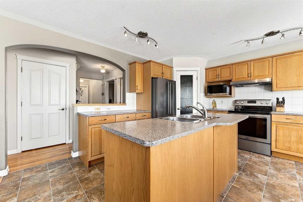 219 Hidden Ranch Circle Nw, Calgary, AB - Indoor Photo Showing Kitchen With Stainless Steel Kitchen With Double Sink