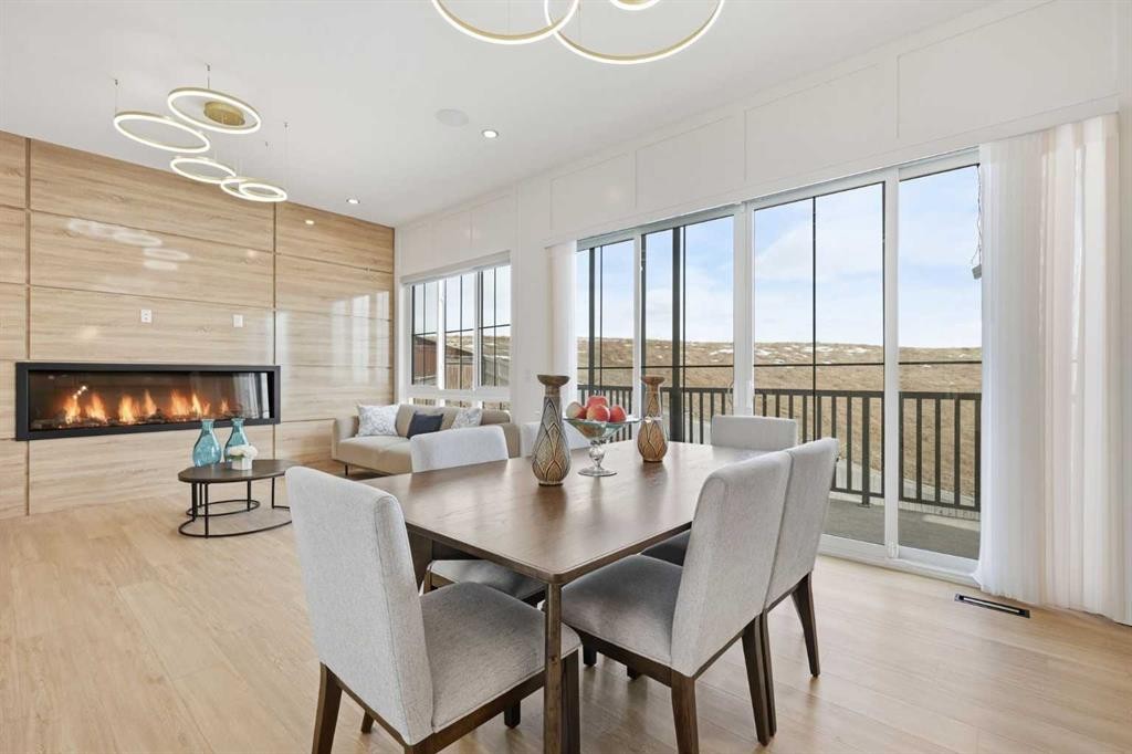 230 Royal Birch View Nw, Calgary, AB - Indoor Photo Showing Dining Room With Fireplace