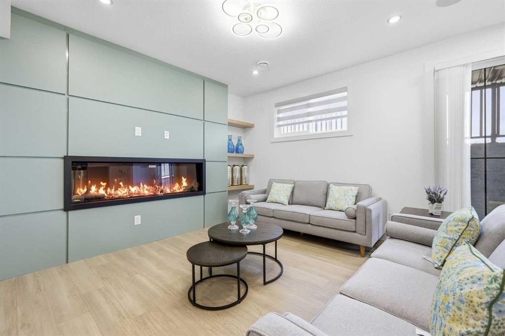 230 Royal Birch View Nw, Calgary, AB - Indoor Photo Showing Living Room With Fireplace