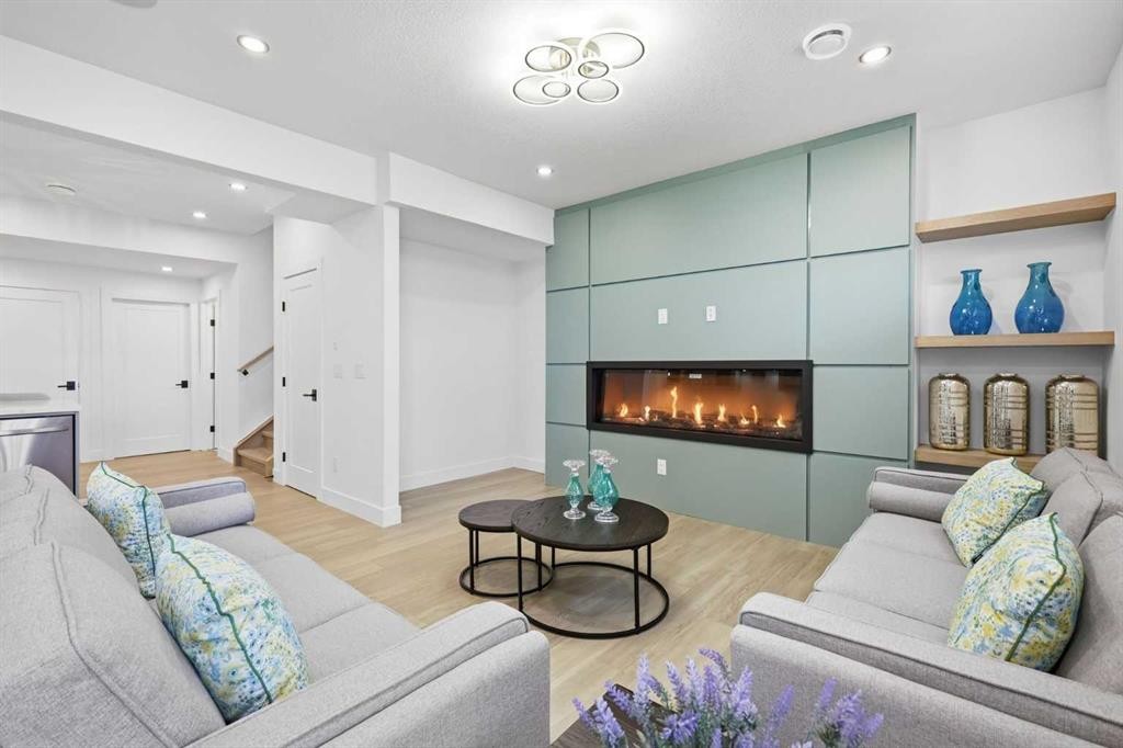 230 Royal Birch View Nw, Calgary, AB - Indoor Photo Showing Living Room With Fireplace