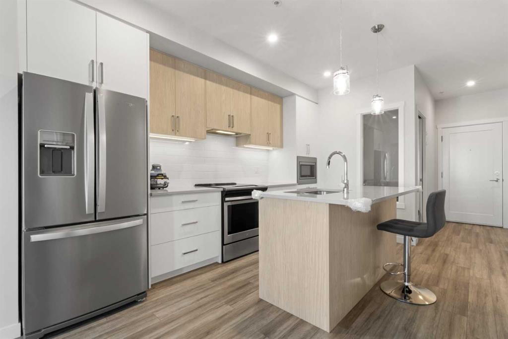 208-138 Sage Valley Common Nw, Calgary, AB - Indoor Photo Showing Kitchen With Stainless Steel Kitchen With Upgraded Kitchen