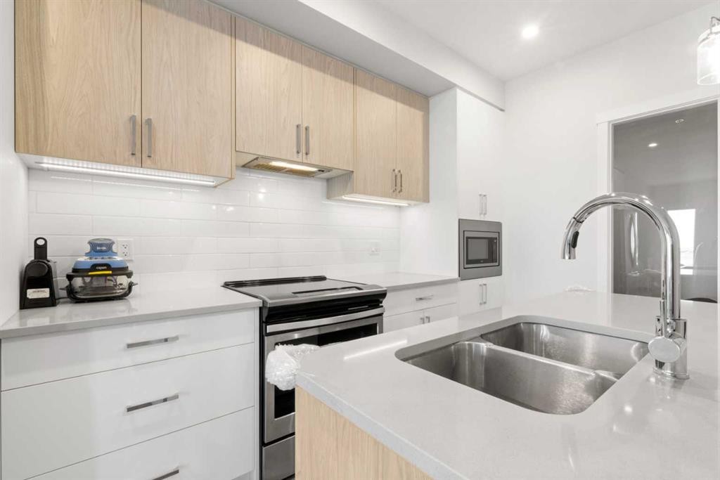 208-138 Sage Valley Common Nw, Calgary, AB - Indoor Photo Showing Kitchen With Double Sink With Upgraded Kitchen
