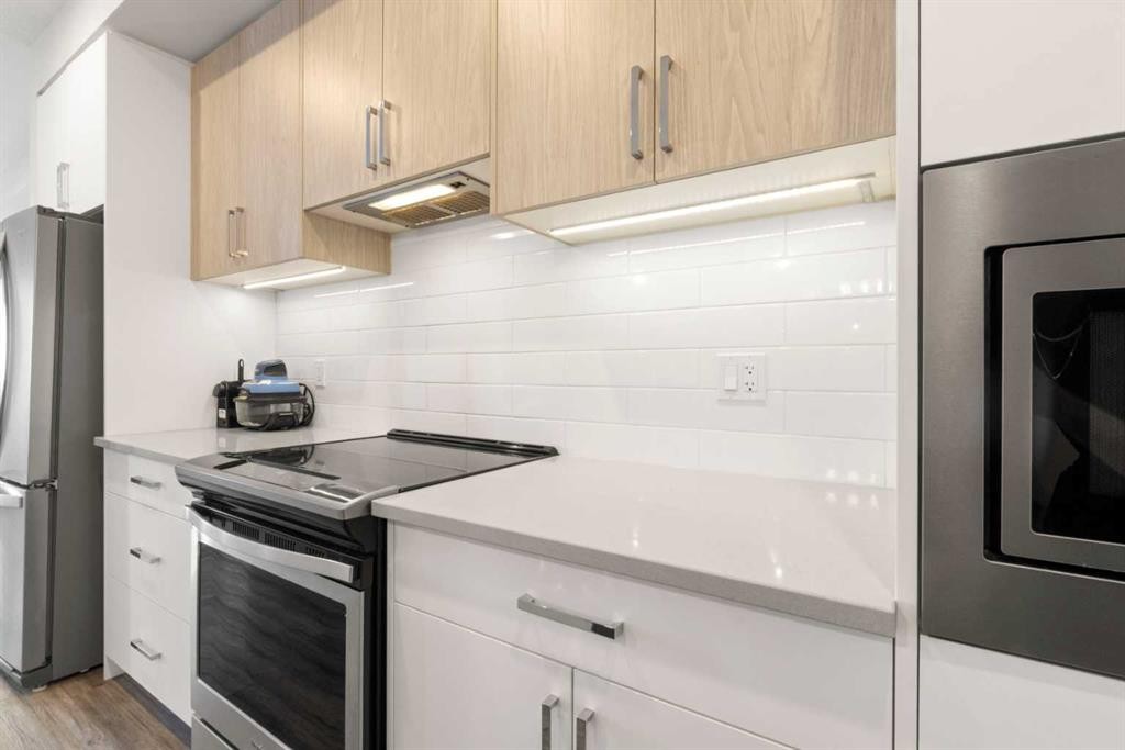 208-138 Sage Valley Common Nw, Calgary, AB - Indoor Photo Showing Kitchen With Stainless Steel Kitchen