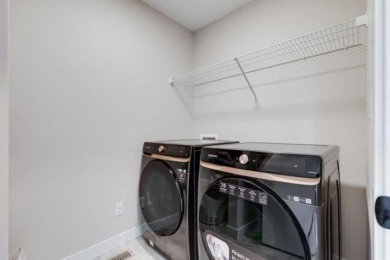 100 Langwell Common Se, Airdrie, AB - Indoor Photo Showing Laundry Room