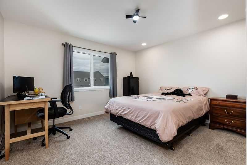 100 Langwell Common Se, Airdrie, AB - Indoor Photo Showing Bedroom