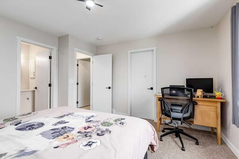 100 Langwell Common Se, Airdrie, AB - Indoor Photo Showing Bedroom