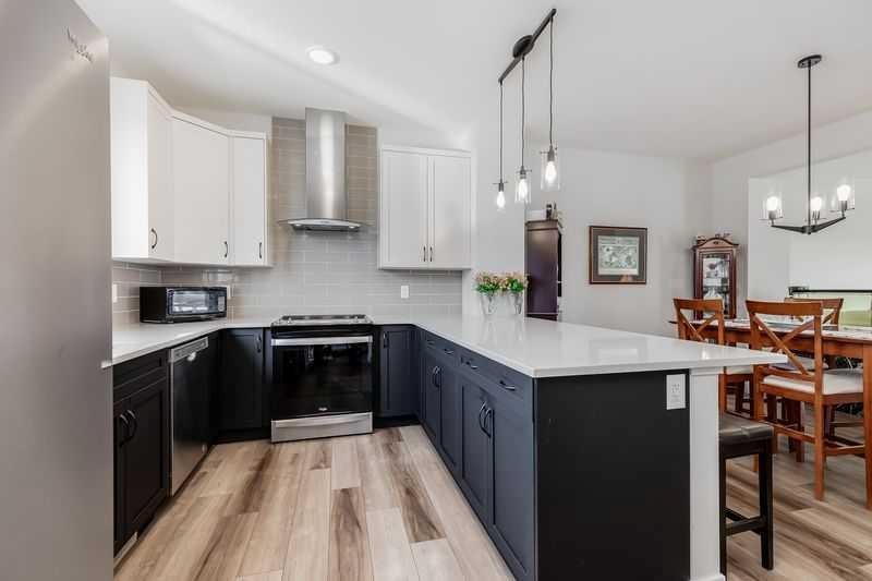 100 Langwell Common Se, Airdrie, AB - Indoor Photo Showing Kitchen With Upgraded Kitchen