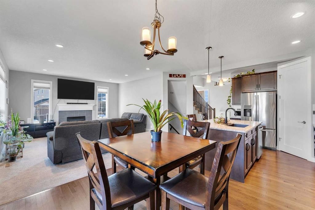 140 Rainbow Falls Heath, Chestermere, AB - Indoor Photo Showing Dining Room With Fireplace