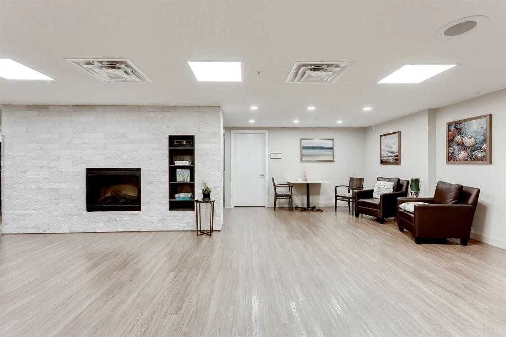 404-2635 Eversyde Avenue Sw, Calgary, AB - Indoor Photo Showing Other Room With Fireplace
