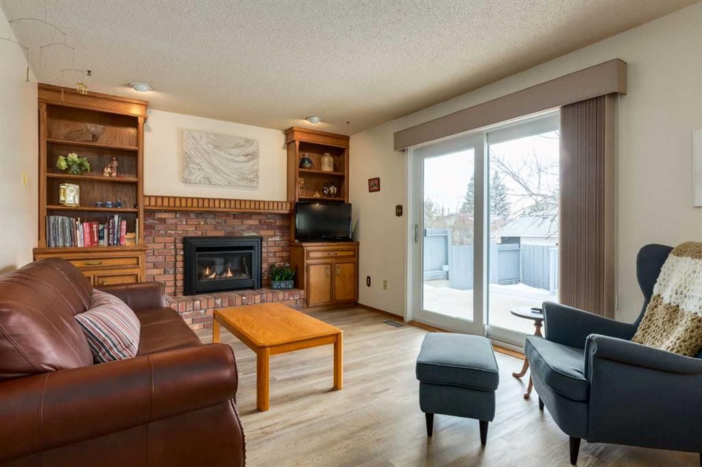 68 Silver Ridge Court Nw, Calgary, AB - Indoor Photo Showing Living Room With Fireplace