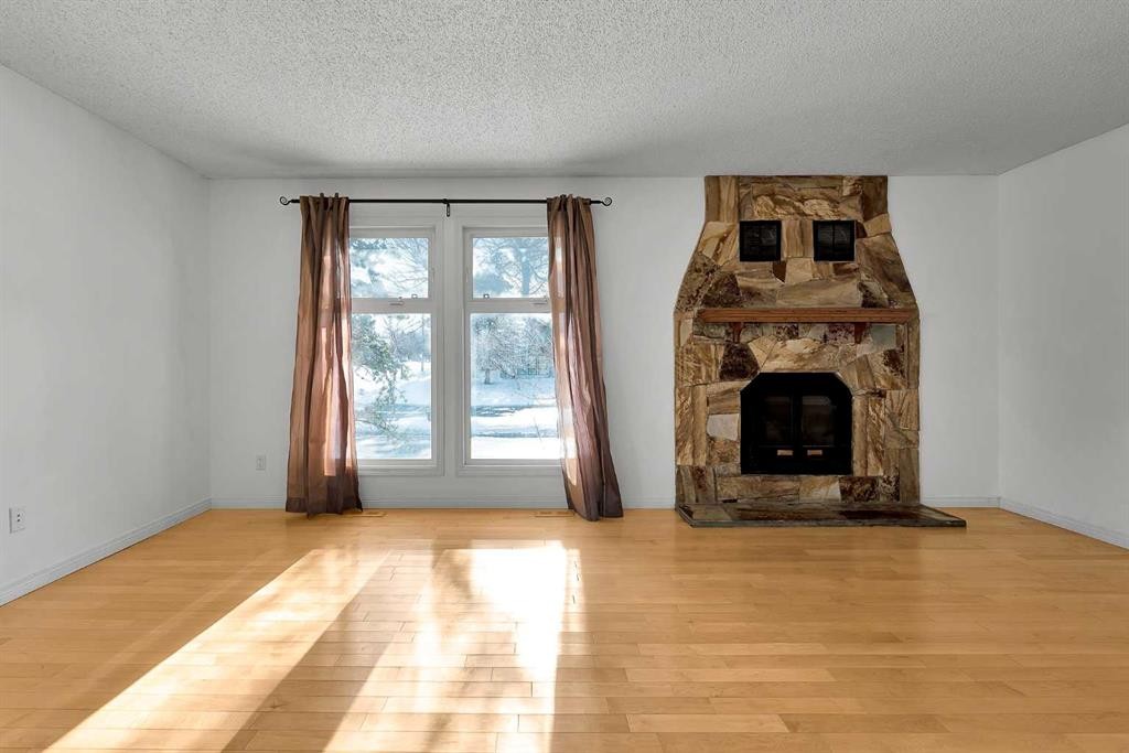 295 Edgepark Boulevard Nw, Calgary, AB - Indoor Photo Showing Living Room With Fireplace