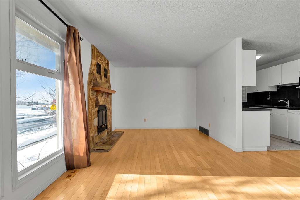 295 Edgepark Boulevard Nw, Calgary, AB - Indoor Photo Showing Kitchen With Fireplace