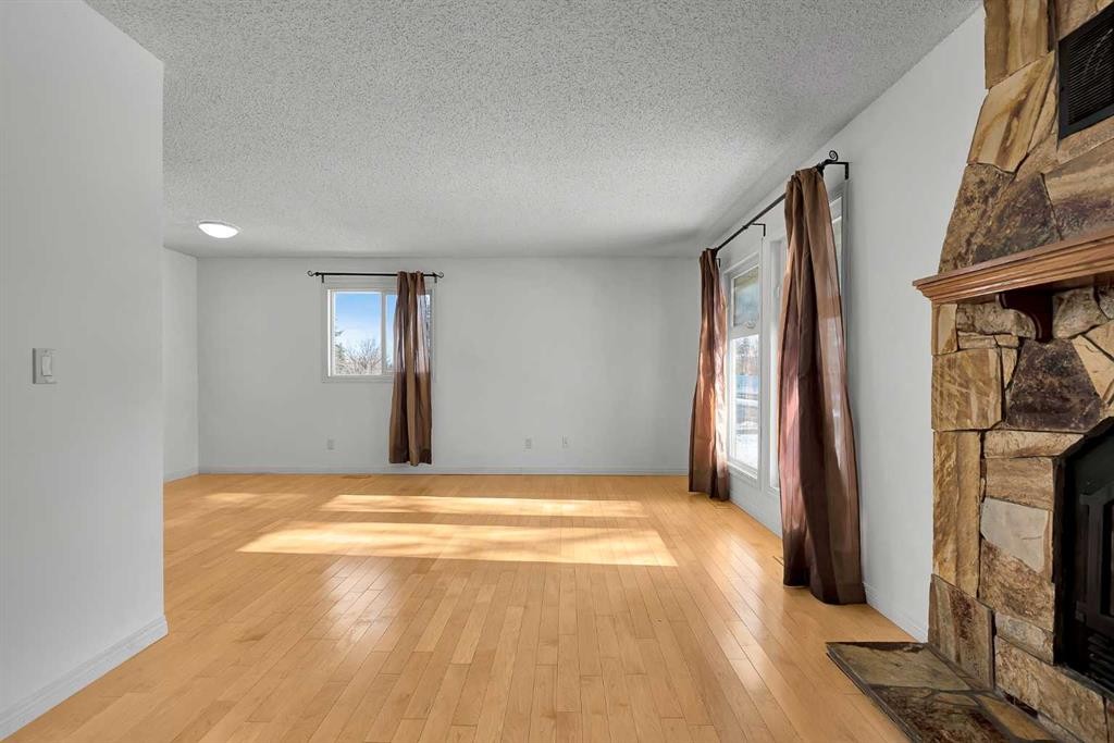 295 Edgepark Boulevard Nw, Calgary, AB - Indoor Photo Showing Other Room With Fireplace