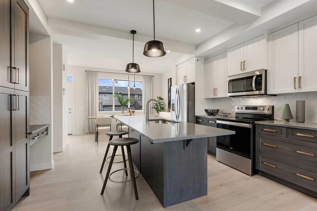 219 Waterford Heights, Chestermere, AB - Indoor Photo Showing Kitchen With Upgraded Kitchen