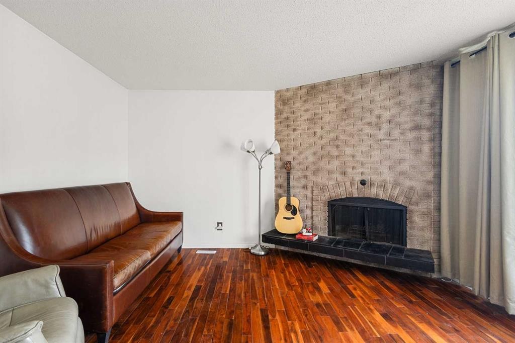 214 Huntington Close Ne, Calgary, AB - Indoor Photo Showing Living Room With Fireplace