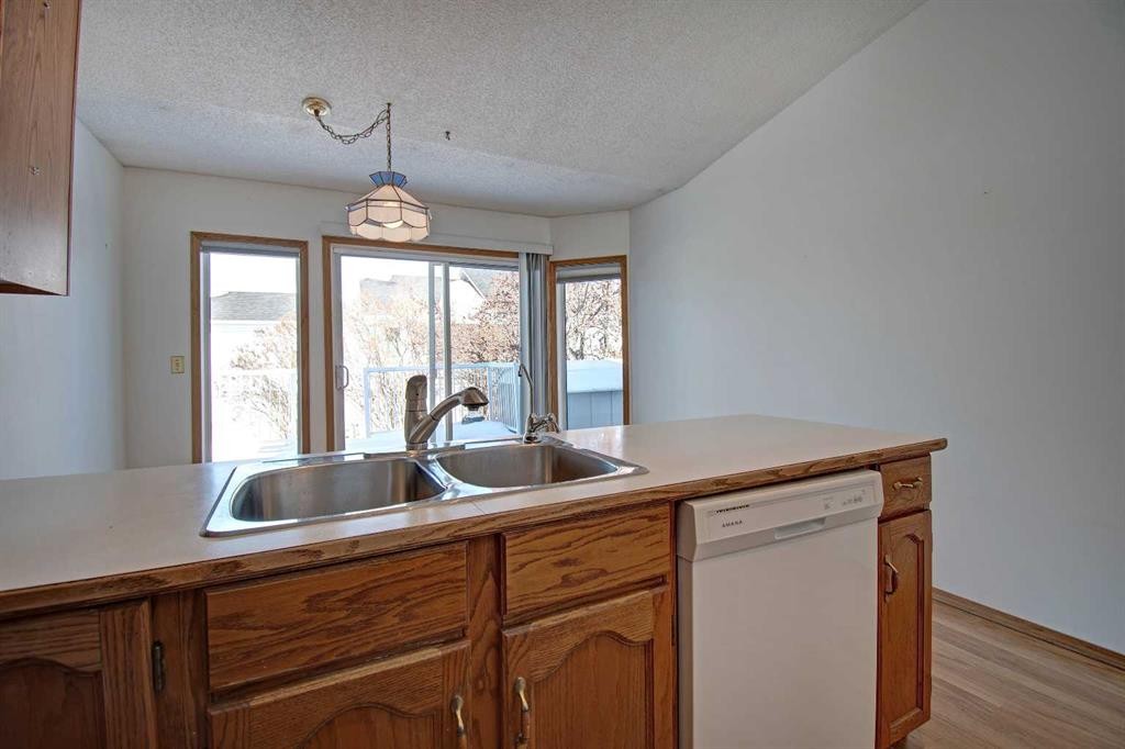 273 Woodside Road Nw, Airdrie, AB - Indoor Photo Showing Kitchen With Double Sink