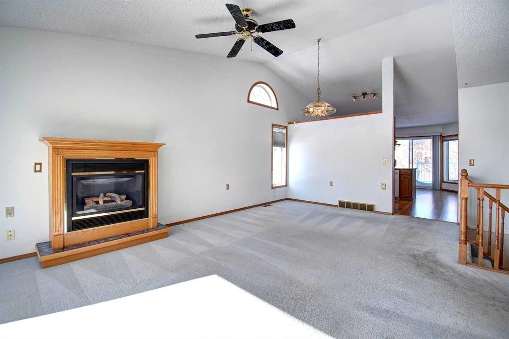 273 Woodside Road Nw, Airdrie, AB - Indoor Photo Showing Living Room With Fireplace