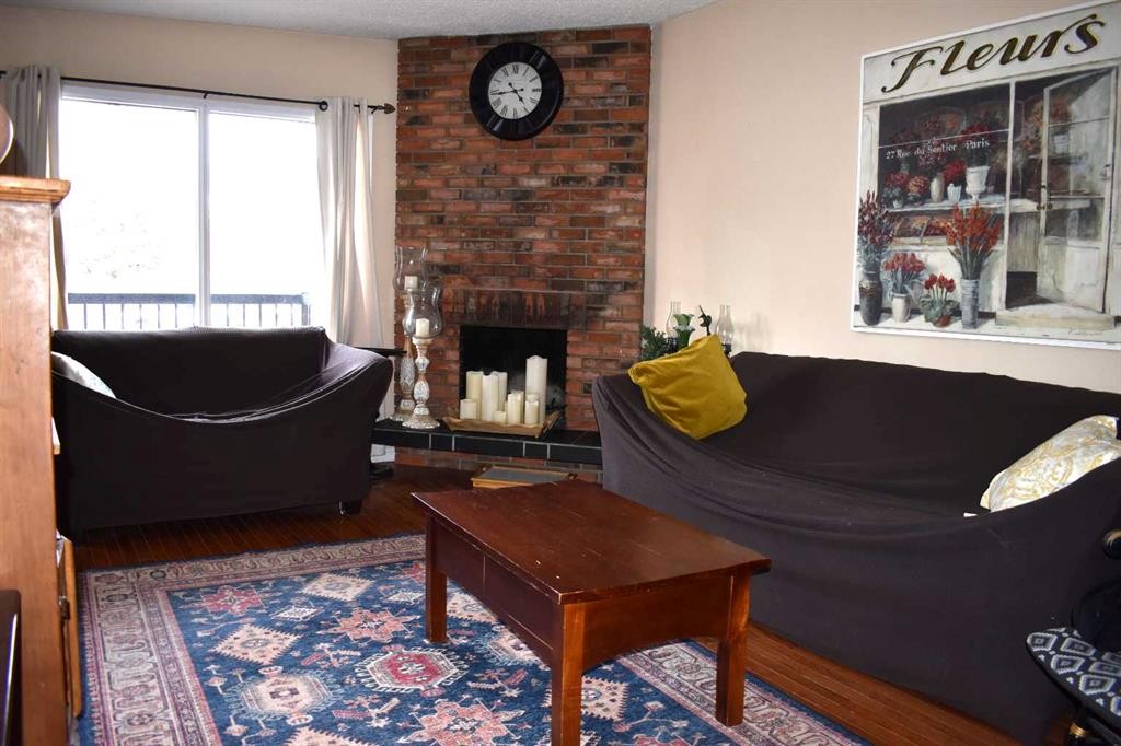 6348 Bowmont Crescent Nw, Calgary, AB - Indoor Photo Showing Living Room With Fireplace