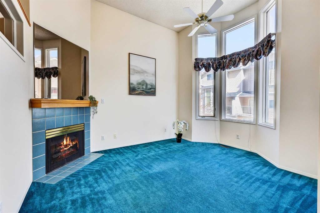 404 Hawkstone Manor Nw, Calgary, AB - Indoor Photo Showing Other Room With Fireplace