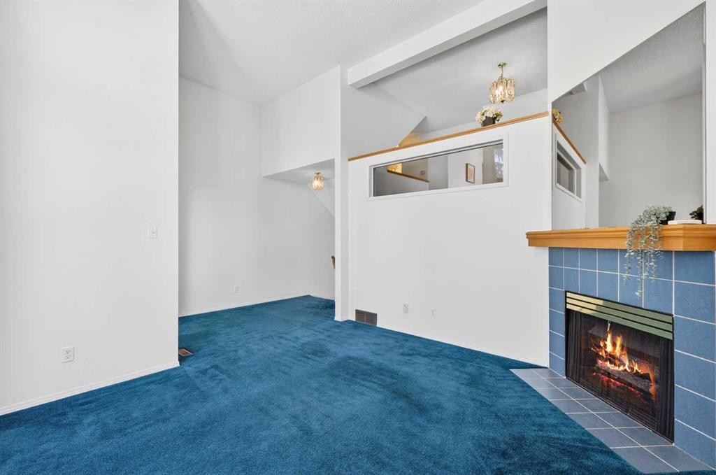 404 Hawkstone Manor Nw, Calgary, AB - Indoor Photo Showing Other Room With Fireplace