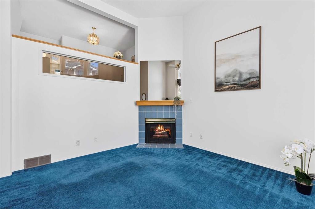 404 Hawkstone Manor Nw, Calgary, AB - Indoor Photo Showing Living Room With Fireplace