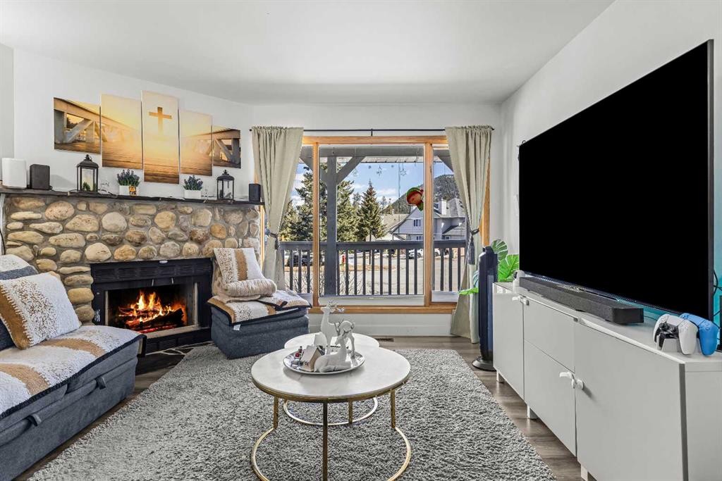 118 Glacier Drive, Banff, AB - Indoor Photo Showing Living Room With Fireplace