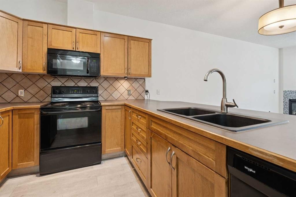 106-3650 Marda Link Sw, Calgary, AB - Indoor Photo Showing Kitchen With Double Sink