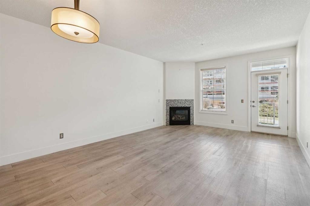 106-3650 Marda Link Sw, Calgary, AB - Indoor With Fireplace
