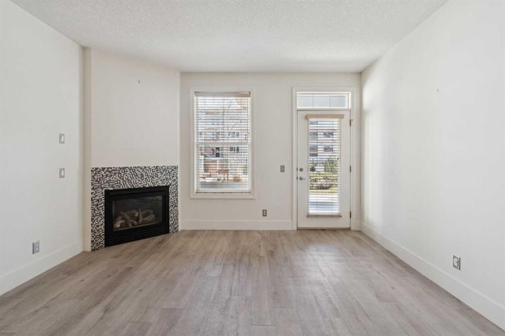 106-3650 Marda Link Sw, Calgary, AB - Indoor Photo Showing Living Room With Fireplace