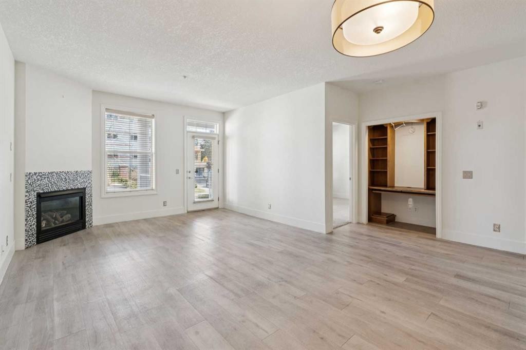 106-3650 Marda Link Sw, Calgary, AB - Indoor Photo Showing Living Room With Fireplace