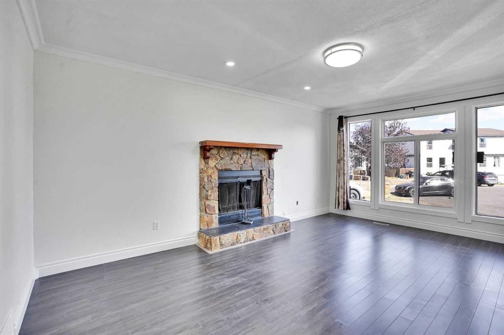 26 Falmead Bay Ne, Calgary, AB - Indoor Photo Showing Living Room With Fireplace