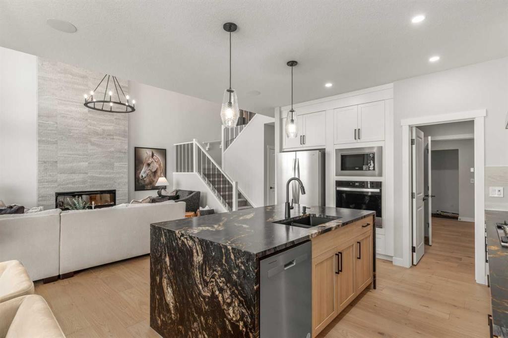 291 Rivercrest Way, Cochrane, AB - Indoor Photo Showing Kitchen With Fireplace With Upgraded Kitchen
