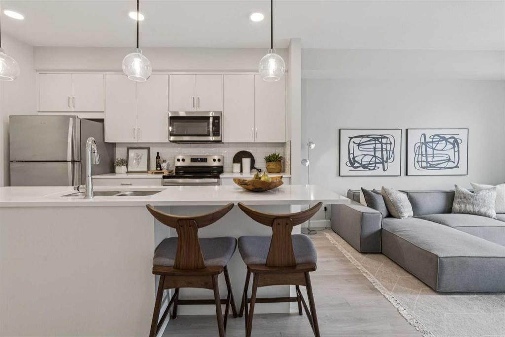 201-655 Shawnee Square Sw, Calgary, AB - Indoor Photo Showing Kitchen With Stainless Steel Kitchen