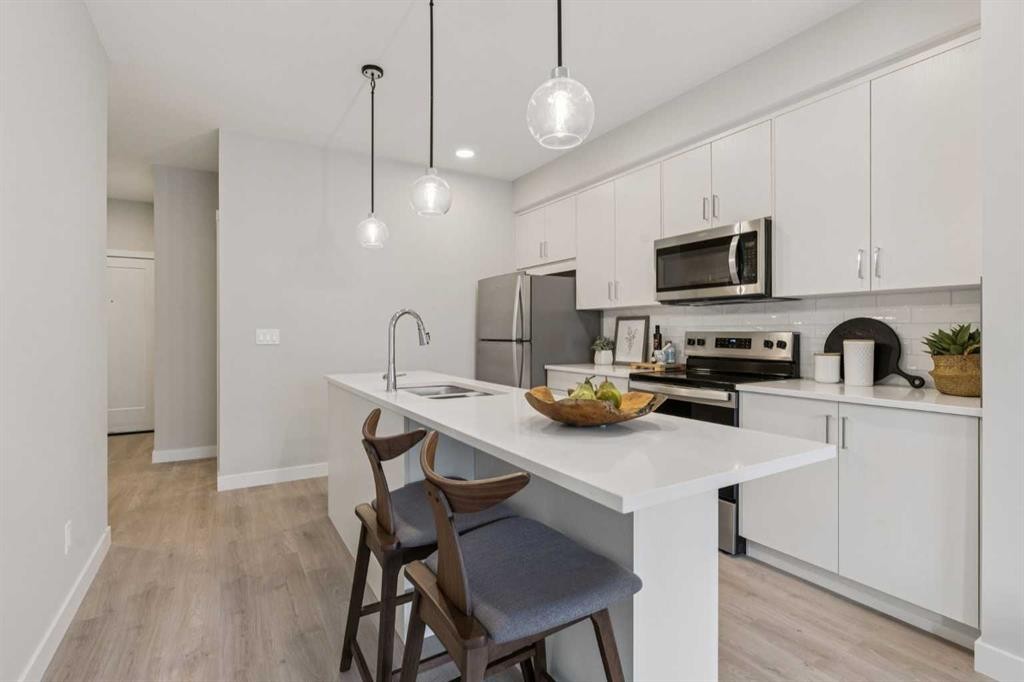 201-655 Shawnee Square Sw, Calgary, AB - Indoor Photo Showing Kitchen With Stainless Steel Kitchen With Upgraded Kitchen