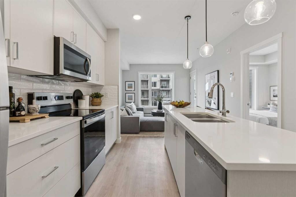 201-655 Shawnee Square Sw, Calgary, AB - Indoor Photo Showing Kitchen With Stainless Steel Kitchen With Double Sink With Upgraded Kitchen