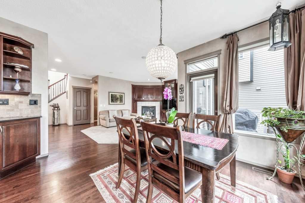40 Cougar Ridge Heights Sw, Calgary, AB - Indoor Photo Showing Dining Room With Fireplace