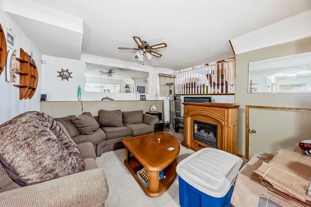 243 Erin Meadow Close, Calgary, AB - Indoor Photo Showing Living Room With Fireplace
