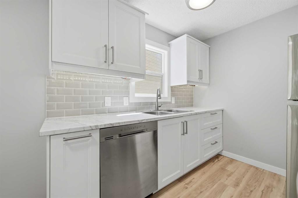 6 Mckernan Place Se, Calgary, AB - Indoor Photo Showing Kitchen With Double Sink
