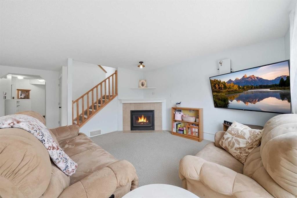 62 New Brighton Circle Se, Calgary, AB - Indoor Photo Showing Living Room With Fireplace