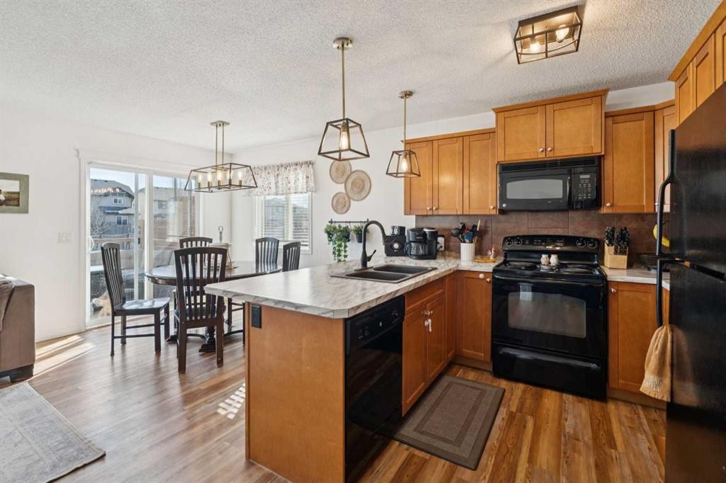 144 Canals Circle Sw, Airdrie, AB - Indoor Photo Showing Kitchen With Double Sink