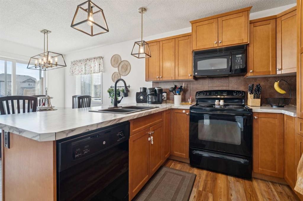 144 Canals Circle Sw, Airdrie, AB - Indoor Photo Showing Kitchen With Double Sink